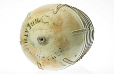 Front view of rounded metal container.