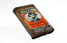Aged metal container with label on side.
