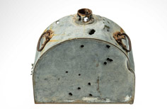 Aged container with handles and small mouth and many holes in it.