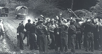 Men gathered on a dirt road waving goodbye.