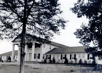 Wide two-story hotel building.