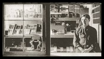 A male cashier waiting for customers at the general store.