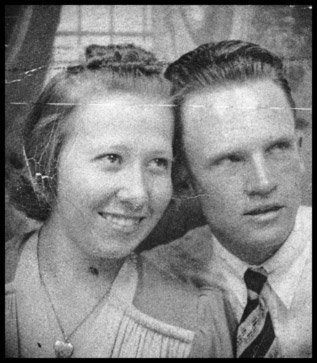 Russell and his wife smile for a photo.