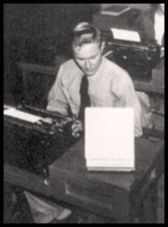 Arthur Emory sits at a typing desk.