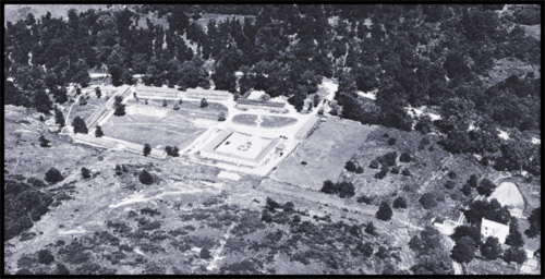 Aerial view of the Front Royal campsite with buildings forming a perimeter around a large open area.