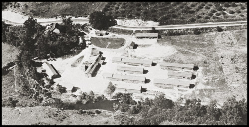Aerial view of the campsite with multiple long structures.