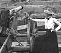 Lou Henry Hoover beside a cannon.