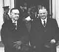 Coolidge standing with Hoover outside.