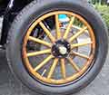 An original wood spoke wheel for an automobile.