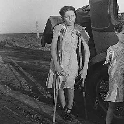 A young girl holding crutches