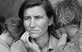 A woman holding her two children during the Great Depression.