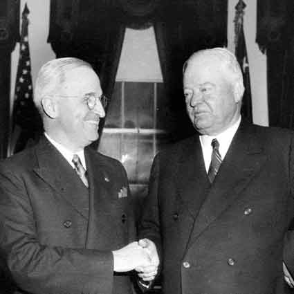 President Truman shakes hands with former President Hoover.