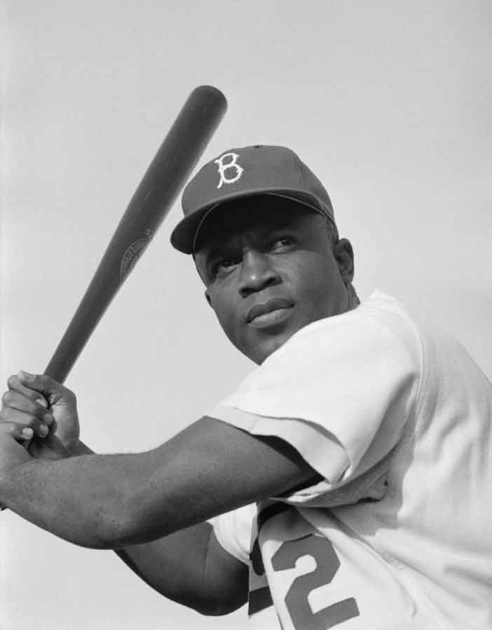 Jackie Robinson holding a baseball bat.