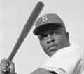Jackie Robinson holding a baseball bat.