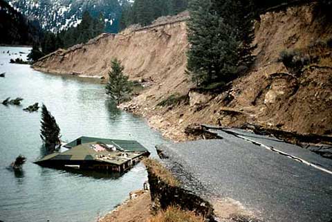 a paved road ends abruptly next to a newly formed lake as the result of an earthquake