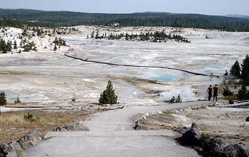 a couple walks down a path toward Porcelain Basin