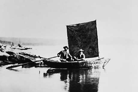 Two men set out on Yellowstone in a small wooden boat with a blanket for a sail in this vintage B&W photo