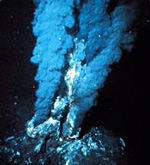 A deep sea vent emits smoky jets from the sea floor