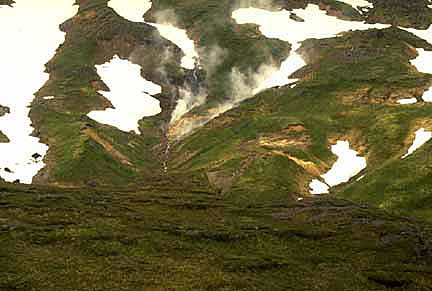 A fumarole steams amind snowdrifts on Umnak Island.