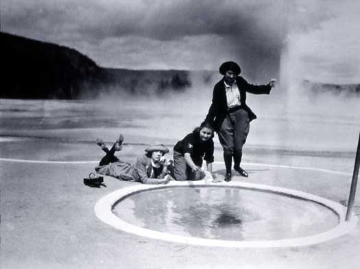 Three women visitors gather at the edge of Handkerchief Pool