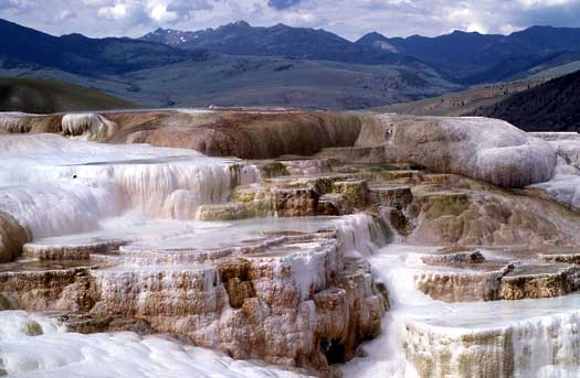 water cascades over colorful terraces at Mammoth