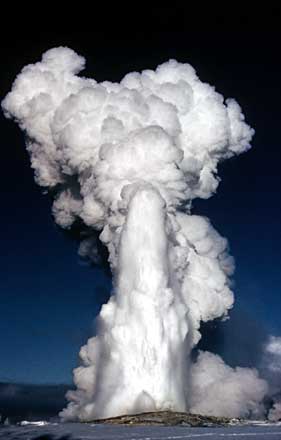 Old Faithful erupts in a hug column of steam and water during the winter