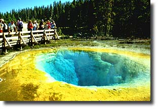 Visitors gaze into the depths of Morning Glory Pool.