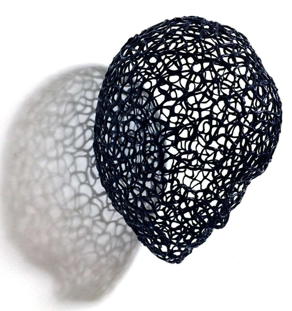 Face by Dong Hee Lee. Black hot glue. 11" x 8" x 8".