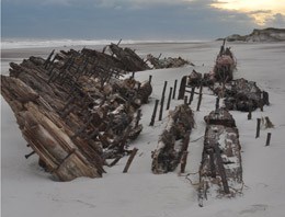 The hull of what is believed to be the wreck of the Bessie White exposed on the beach after Hurricane Sandy.