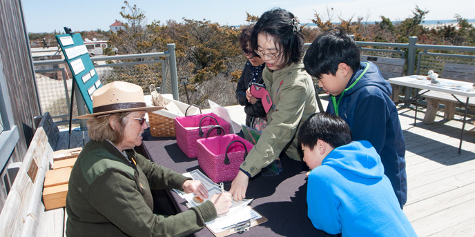 A park ranger welcomes young visitors to Fire Island.