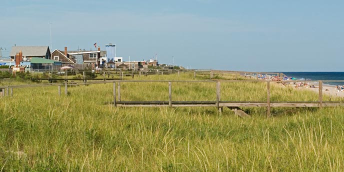 View looking east of beach houses boardwalks and ocean beach on Fire Island.