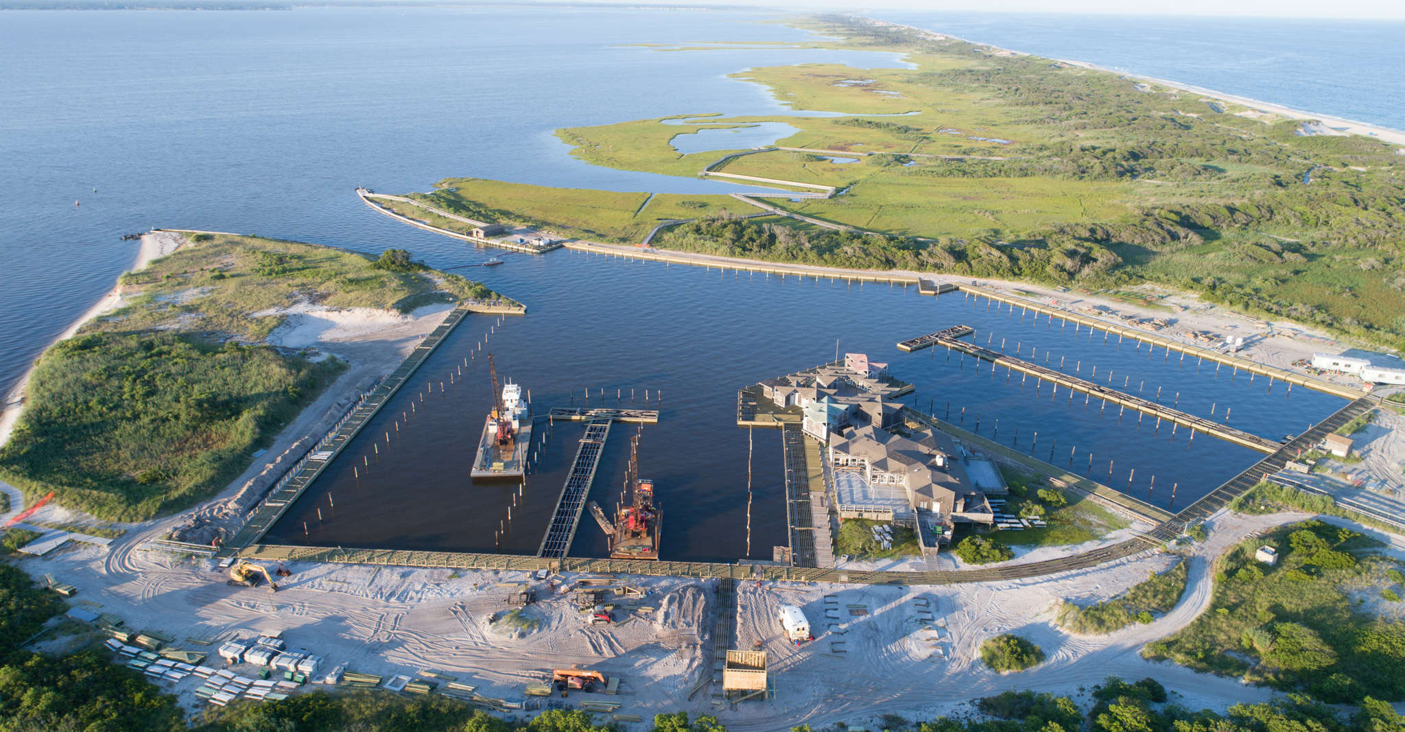 Aerial photograph of marina on bay side of barrier island.