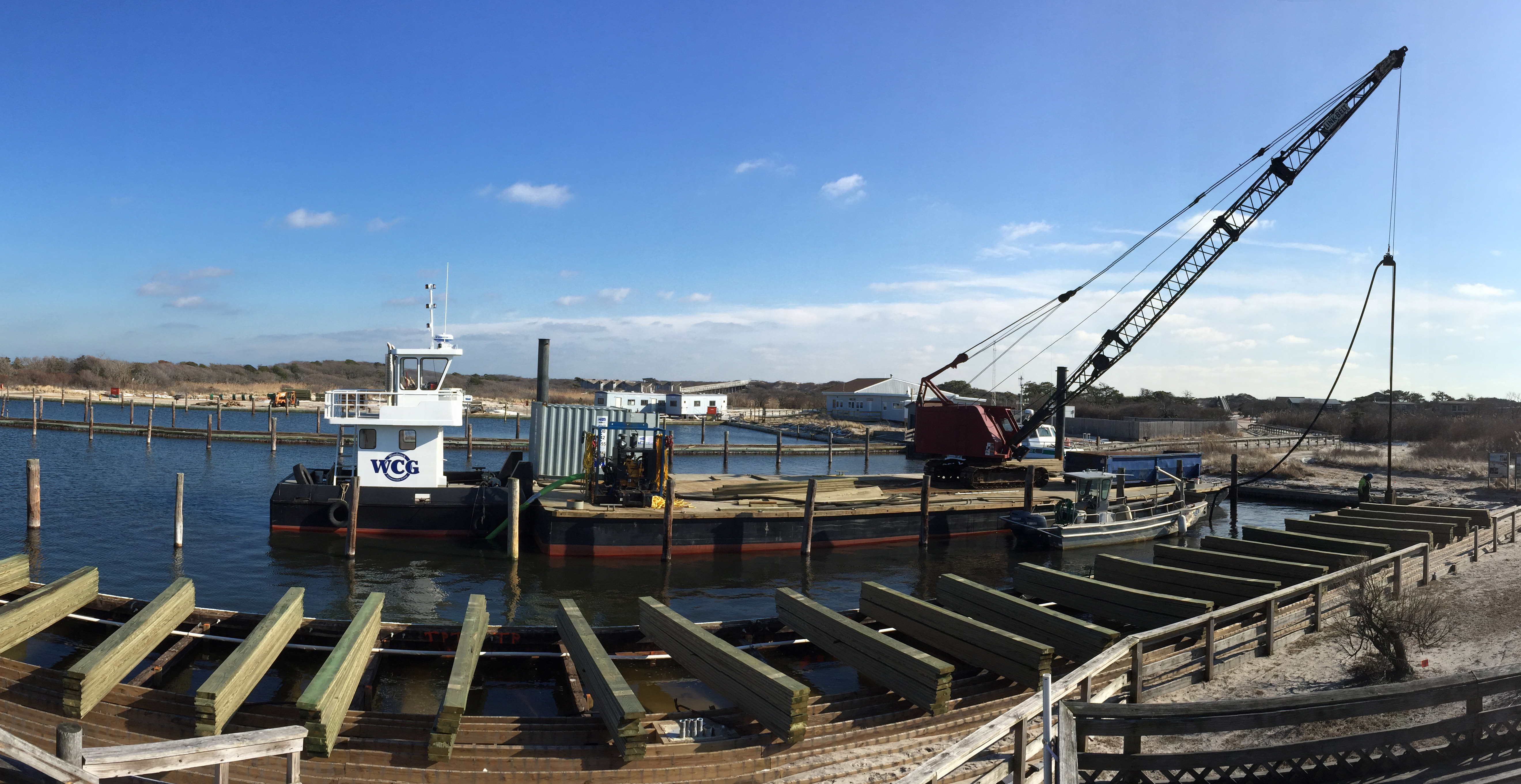 View of construction including a crane occurring at the Watch Hill Marina