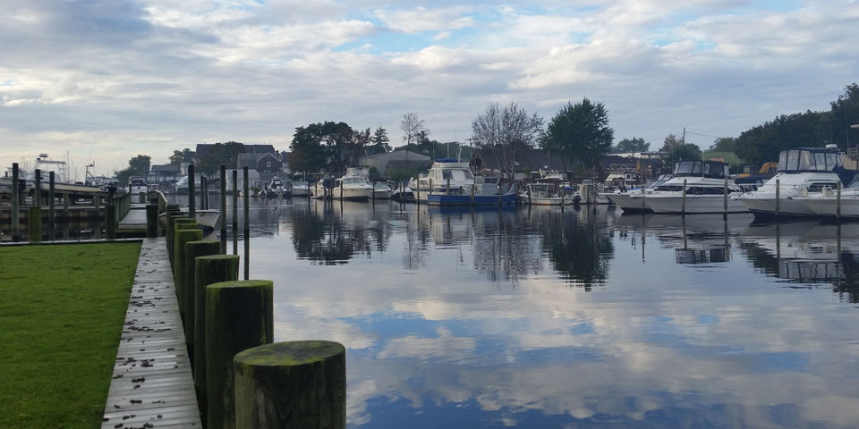 View of river reflecting cloudy sky