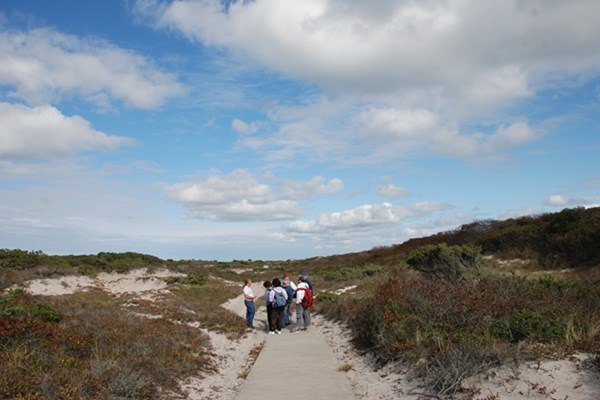 Group on trail through swale at Sailors Haven.