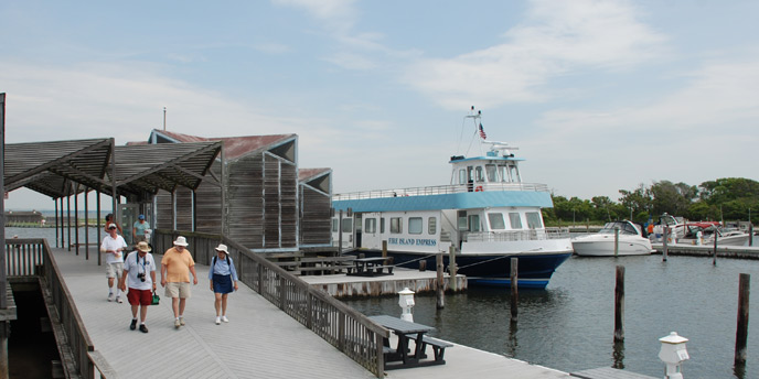 Visitors walk on the Watch Hill boardwalk to the beach. Visitors walk on the Watch Hill boardwalk to the beach.