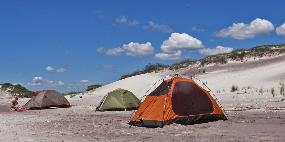 Camping tents along the dunes.