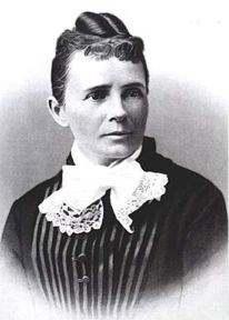 A black-and-white photo of Lucretia Garfield wearing a black blouse with a frilly white neckerchief.