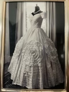Jackie's Replica Wedding Gown on a mannequin with a string of pearls around the neck