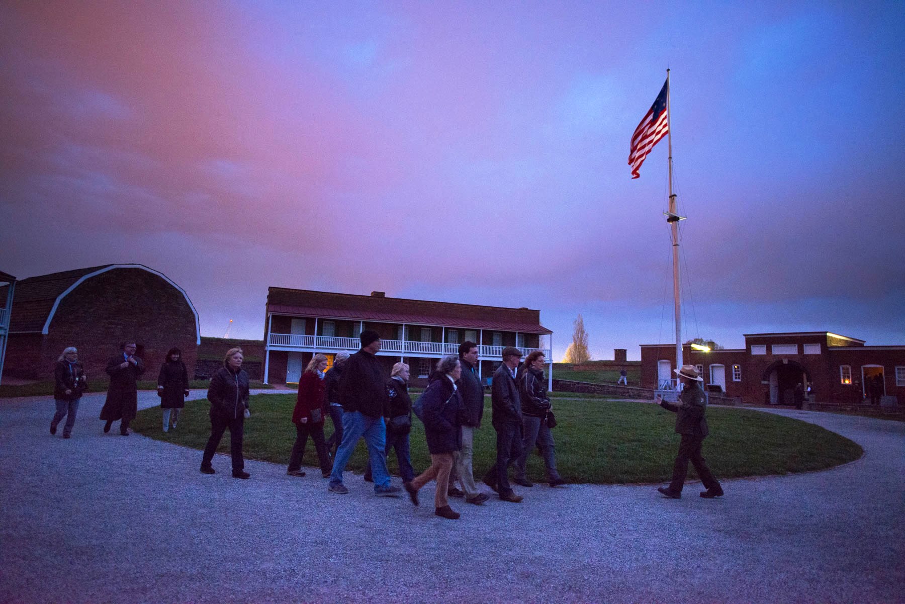 Park Ranger guiding visitors through the Star Fort during a candlelight tour. Park Ranger guiding visitors through the Star Fort during a candlelight tour.