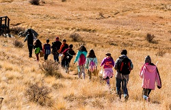 Rangerl leading students on hike through meadow