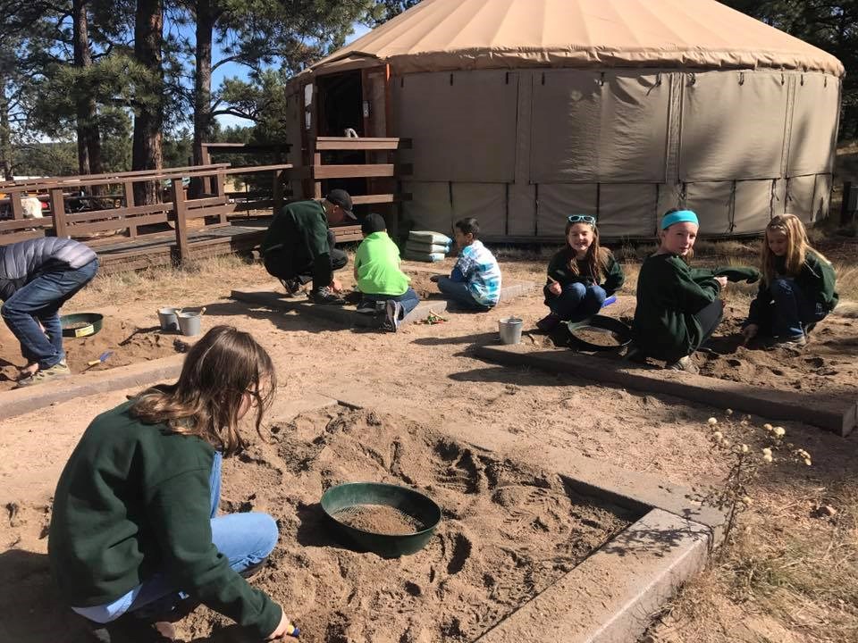Kids using the sandbox to look for fossils