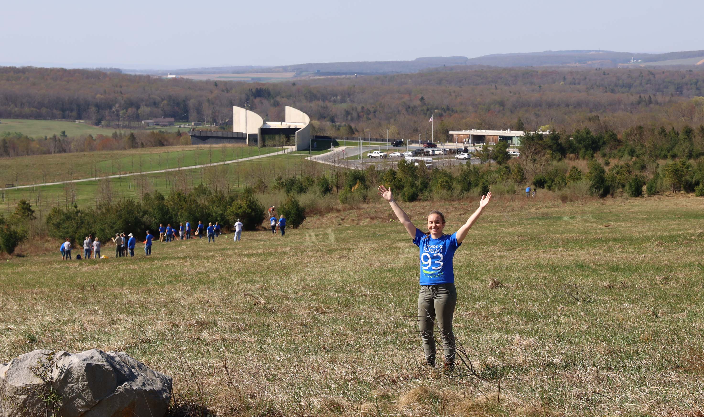 2023 Earth Day Image Volunteers work to plant trees and wildflowers on the hill overlooking the Visitor Center.
