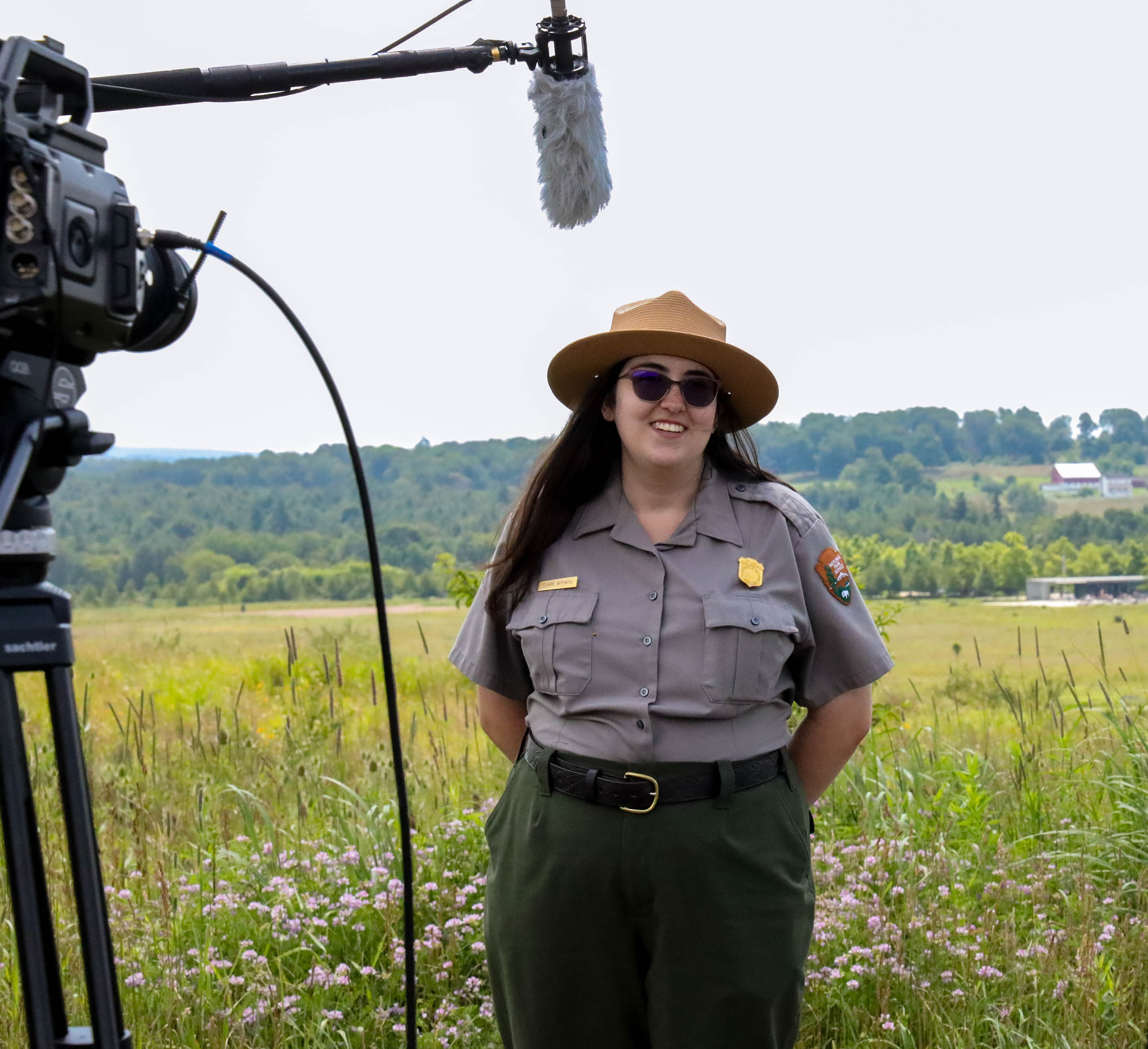 Ranger Claire stands in front of camera for the National Day of Learning. Park Ranger stands in front of a camera at Flight 93 National Memorial