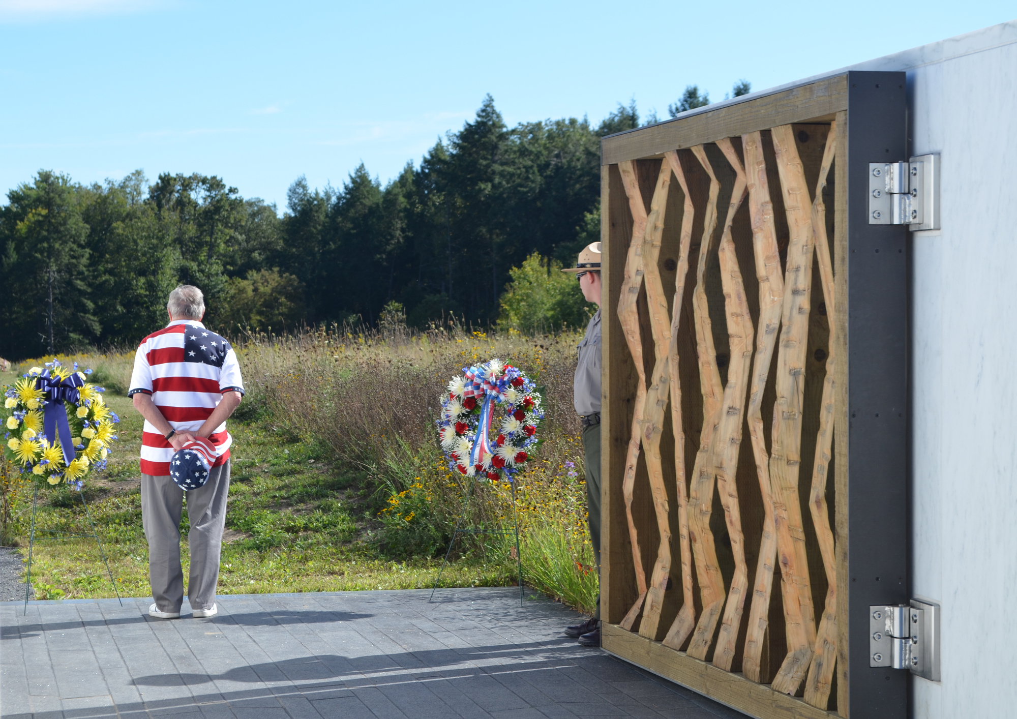 Visitor looking down the flight path to  the impact site through the open Ceremonial Gate