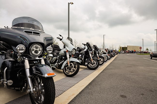 Motorcycles parked along the sidewalk near the Visitor Center.