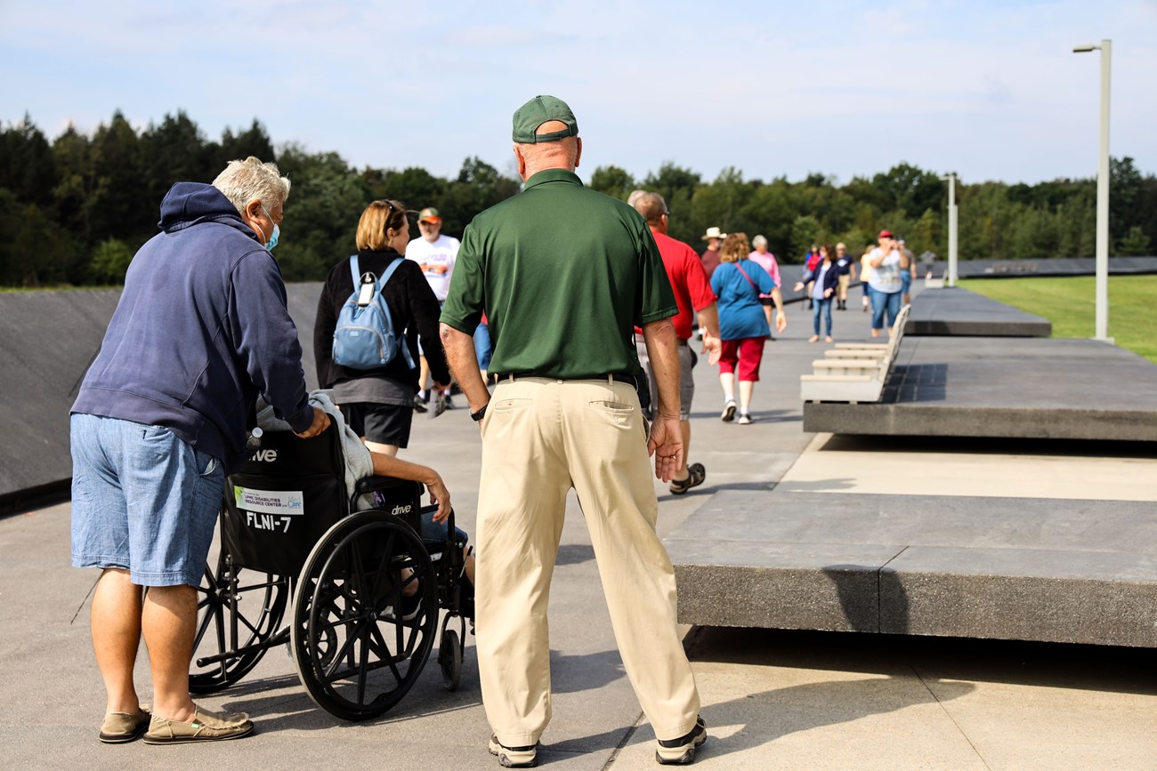 Volunteer assisting visitors.