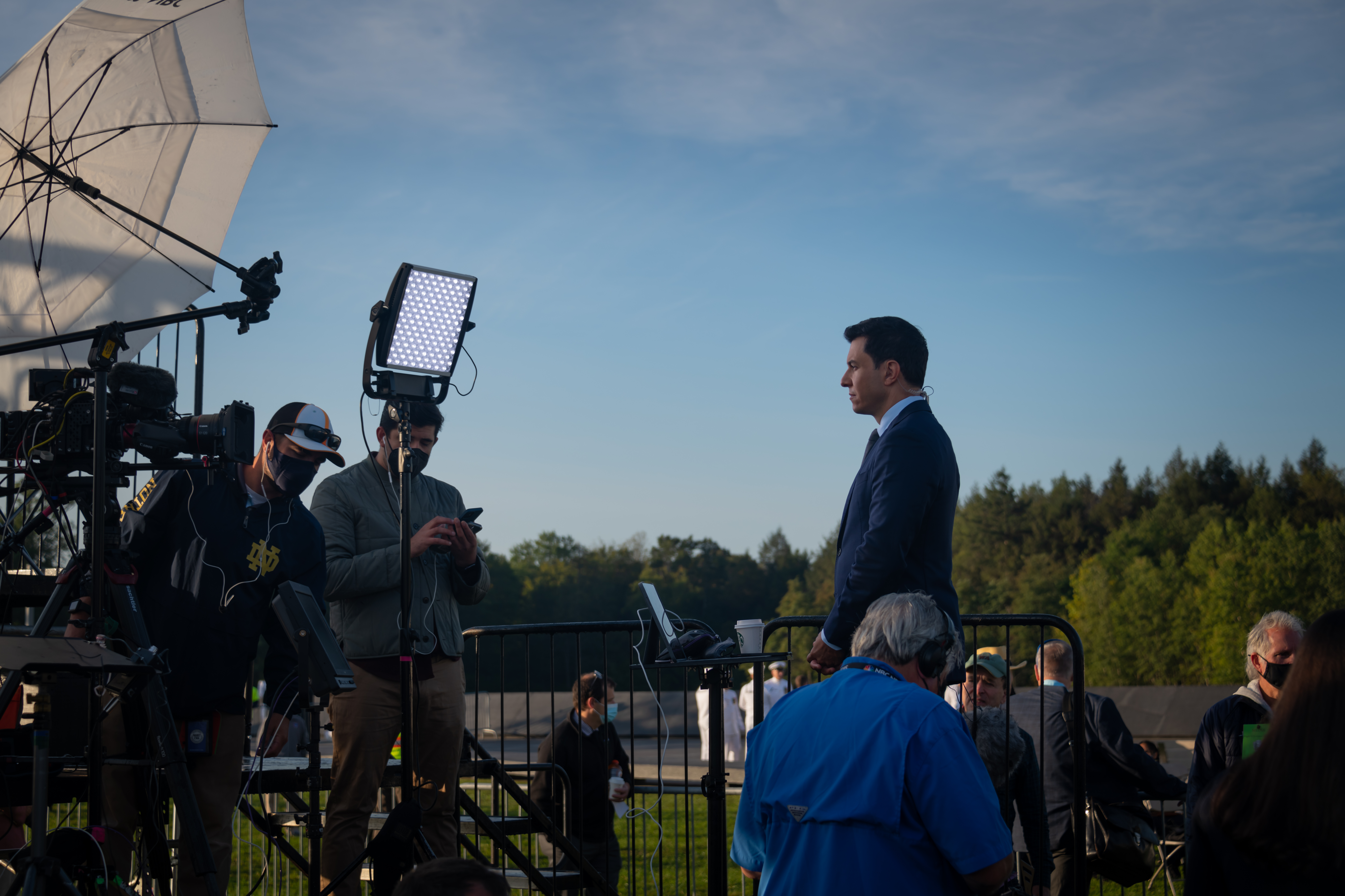 Journalist being filmed by cameras.