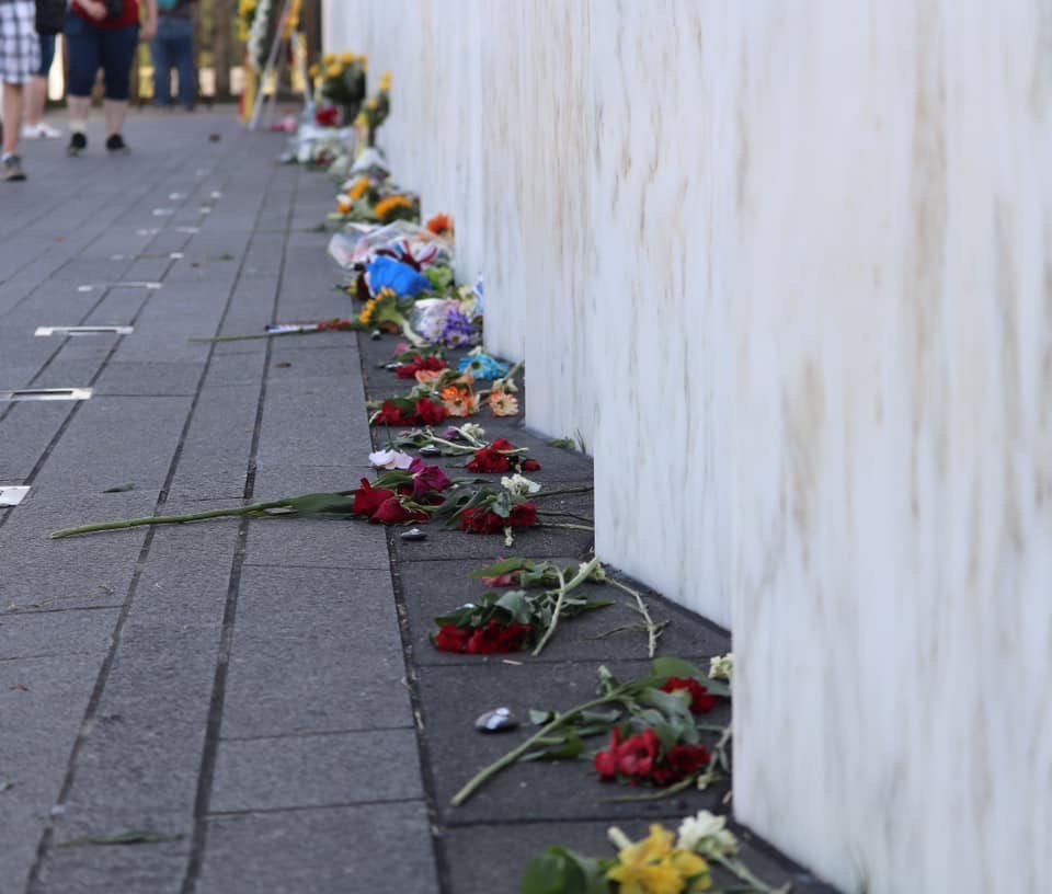 Flowers laying against the Wall of Names