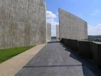 Long black walkway and tall gray walls